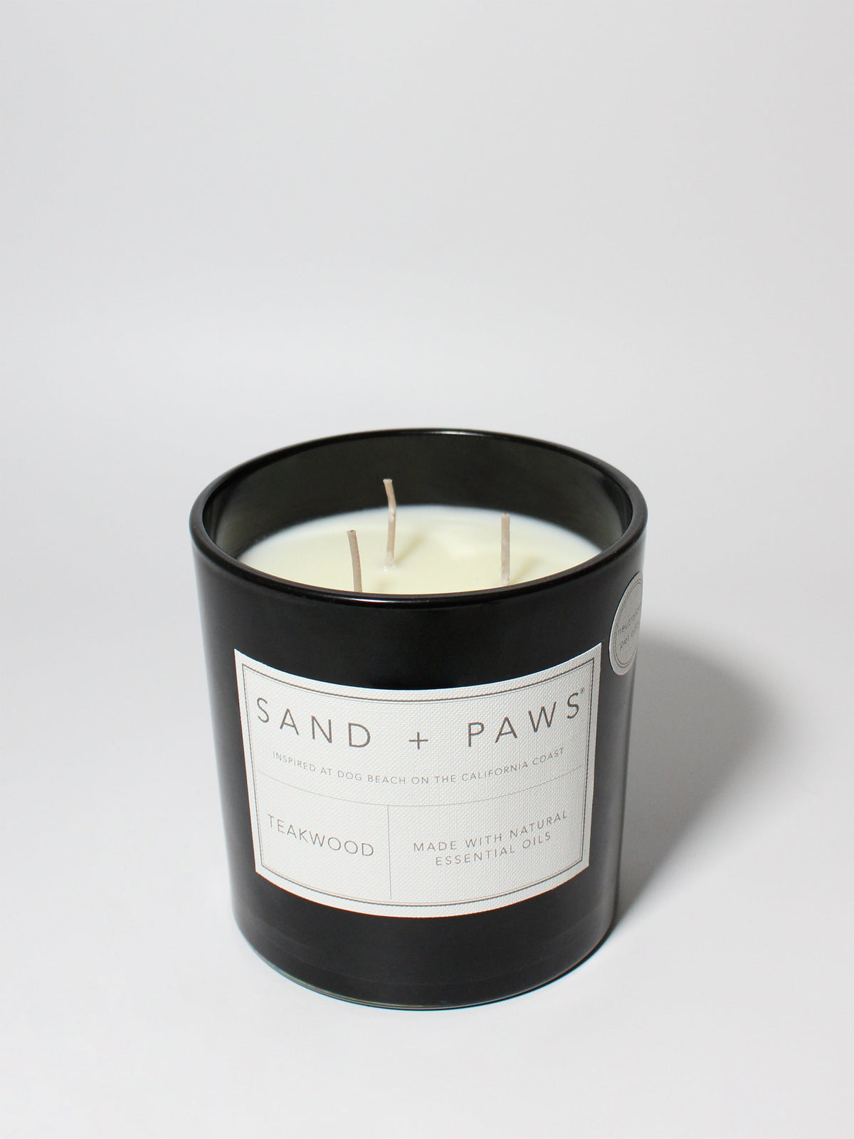 Sand + Paws Teakwood 21 oz scented candle Black vessel with Paw in Heart lid